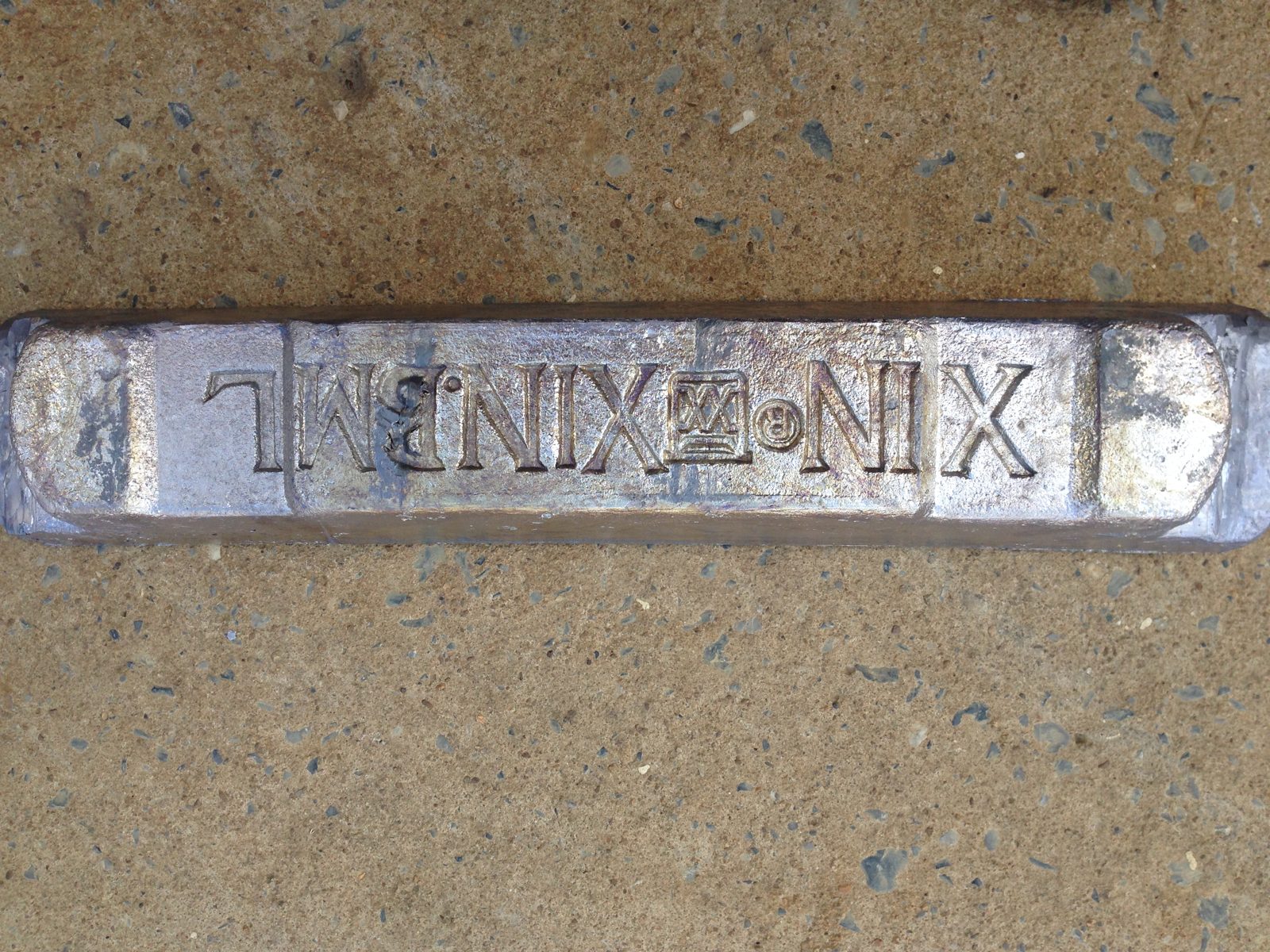 XIN XIN.BML brand stamp on a pure lead ingot